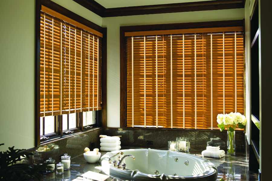 Wood blinds on two bathroom windows